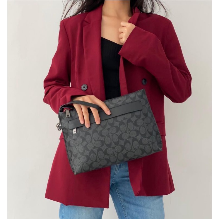 Clutch Coach carryall pouch in signature