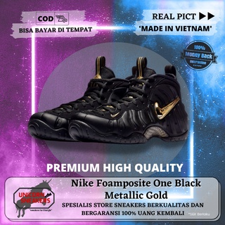 all black foams with gold nike sign