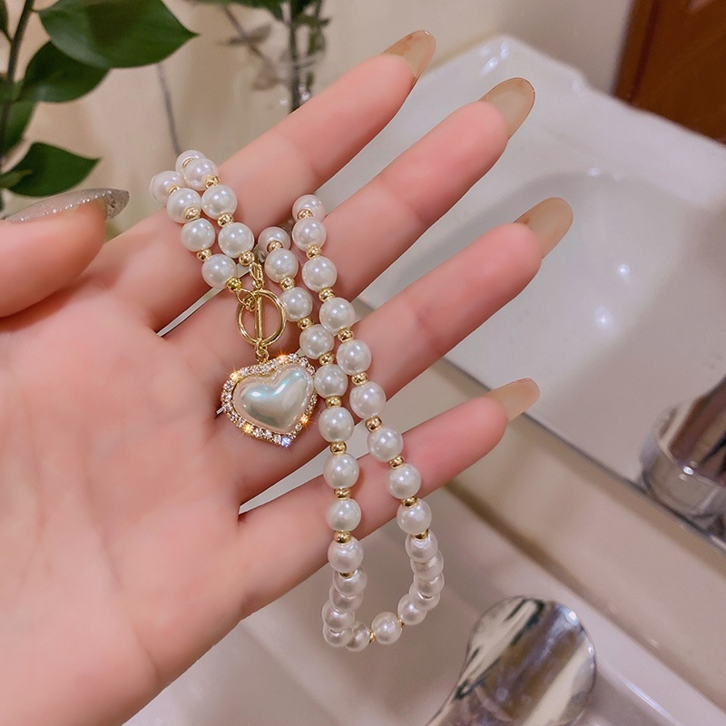 Korea Fashion Wanita Cahaya Mewah Elegan Retro Mutiara Cinta Liontin Kalung