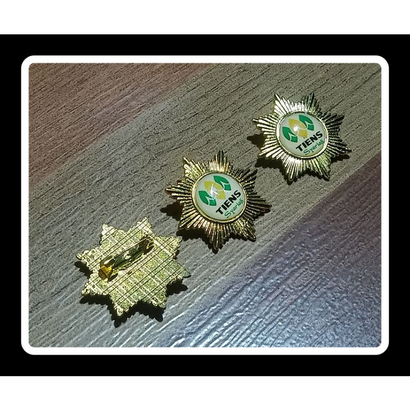 pin TIENS design matahari lapis emas