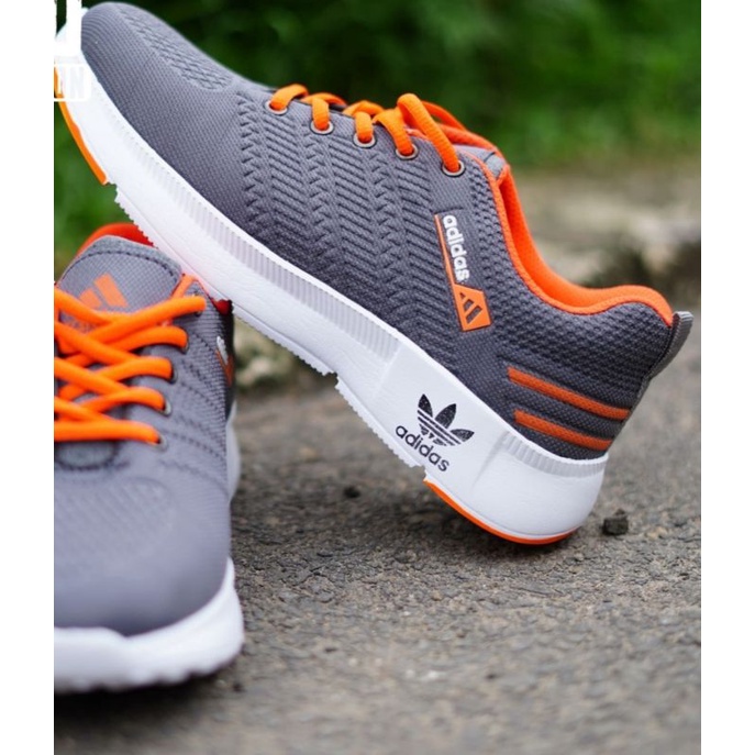 Sepatu Wanita Pria Logo Timbul Floging - Sepatu olahraga no import-Ads Abu Orange