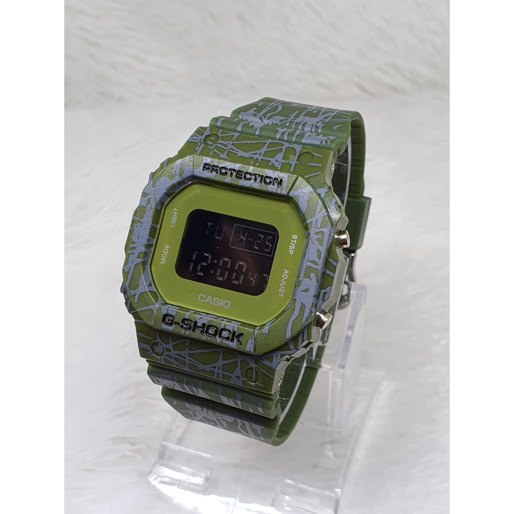 TERLARIS!!!JAM TANGAN PRIA G-SHOCK CASIO DW 5600 GS CASIO SEGI WARNA HITAM ANTI AIR DIGITAL one piece dw bunga dw loreng full hitam best seller ready stock TERIMA COD BAYAR DITEMPAT-TRIBAL HIJAU
