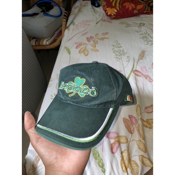 Topi second IRELAND tag putih setelan besi warna emas