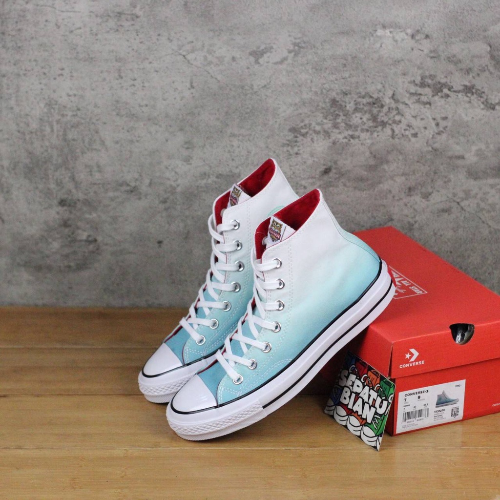 white patterned converse