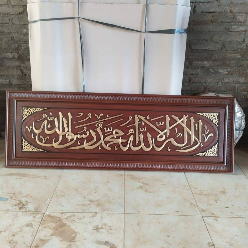 Kaligrafi kalimat tauhid ukir timbul kayu jati ukuran 150cm x 50cm