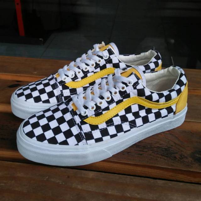 black and white checkerboard vans with yellow stripe