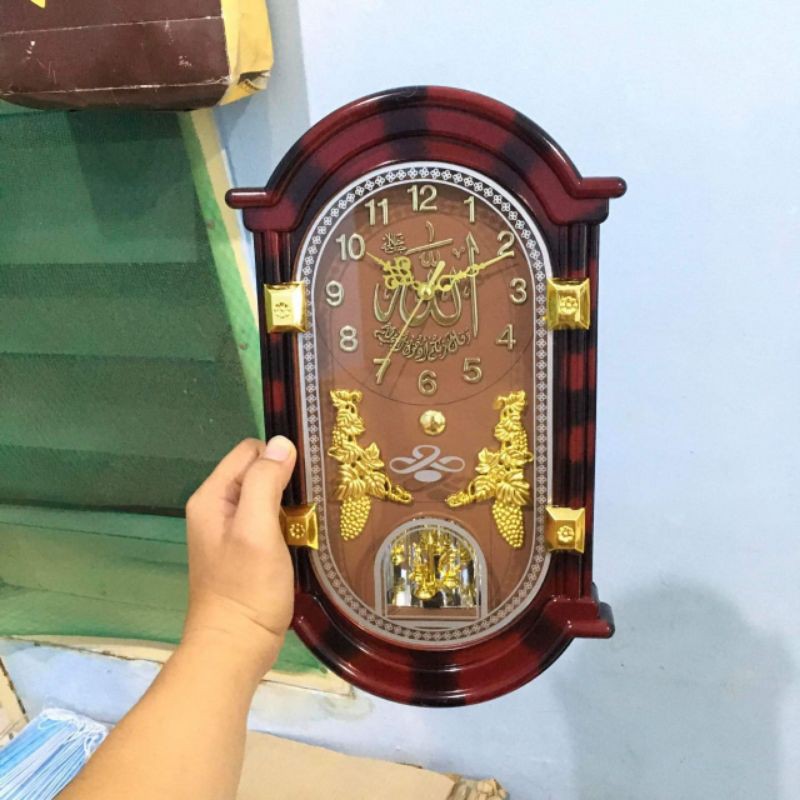 jam dinding bandul putar kaligrafi bunyi perjam