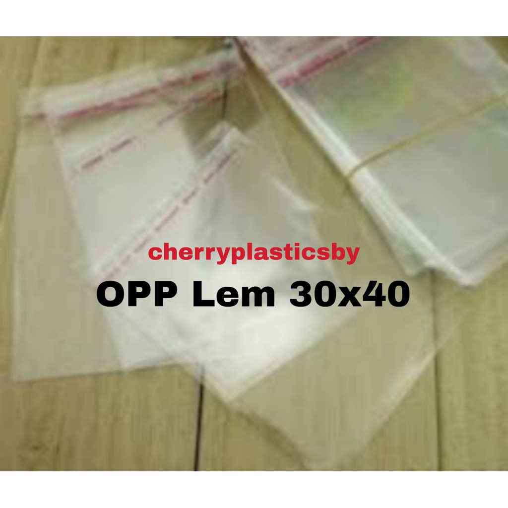 OPP Lem 30x40 cm Plastik Baju pak 100pc