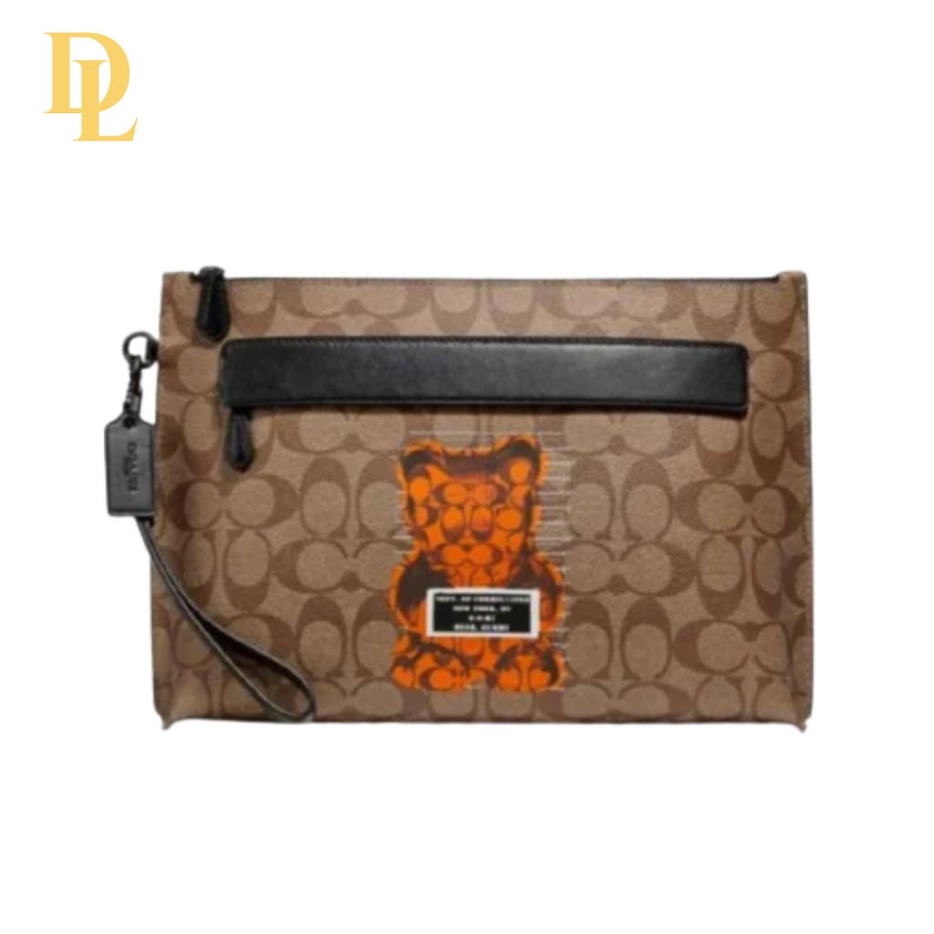 COACH CLUTCH MEN BROWN SIGNATURE WITH ORANGE BEAR