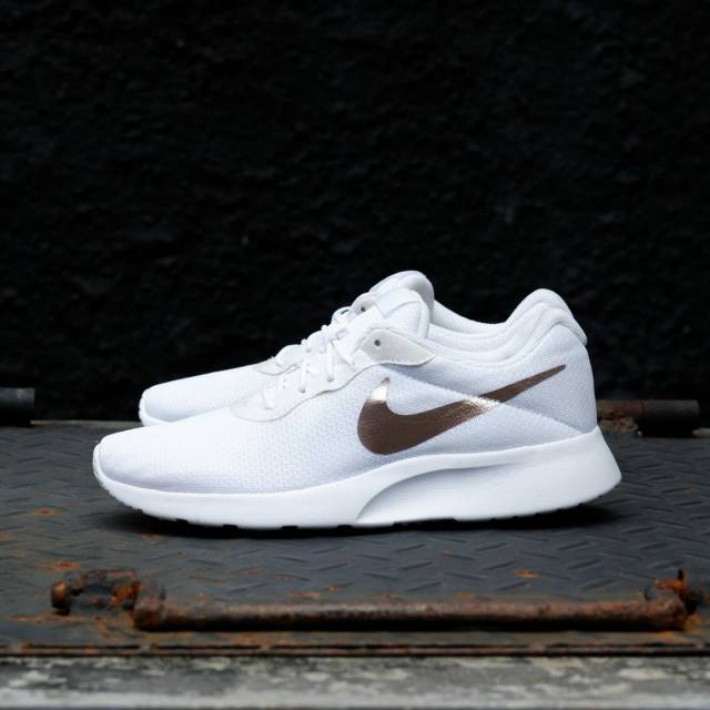 white and rose gold nike shoes