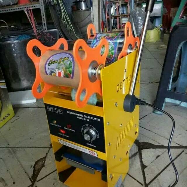 Mesin pres gelas minuman bunus plastik lid