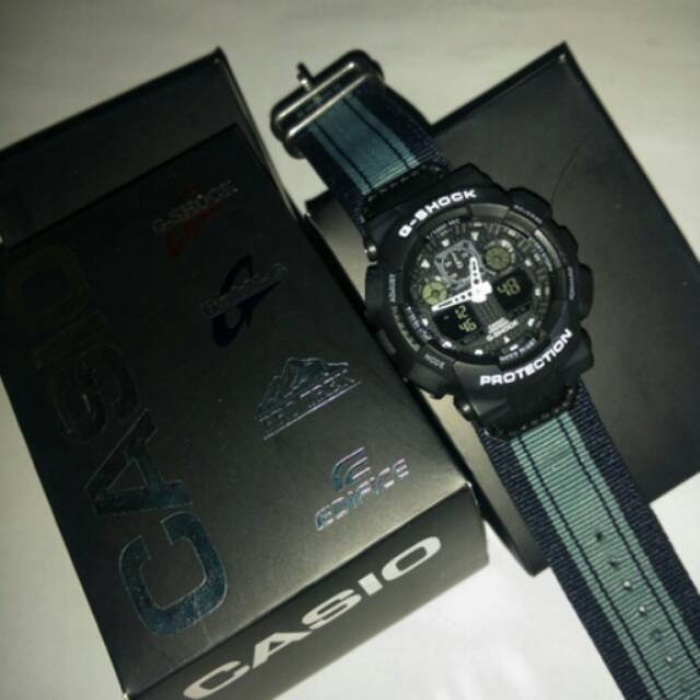 Jam tangan pria Casio G-Shock Ga100 srap/tali kanvas abu-abu  Kws