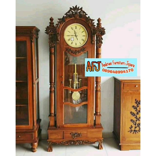 Almari jam hias ruang tamu bahan kayu jati