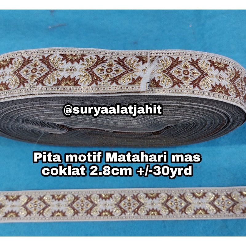 Pita motif Matahari mas coklat 2.8cm +/-30yrd TERBARU =rp.95.000/1Rol