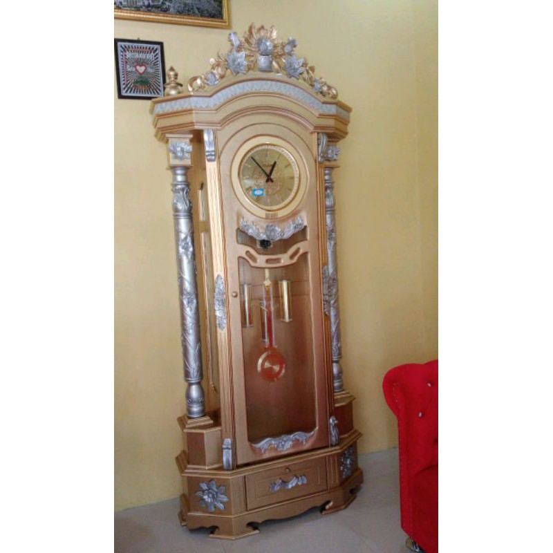 Lemari jam hias kayu jati cat duco warna gold