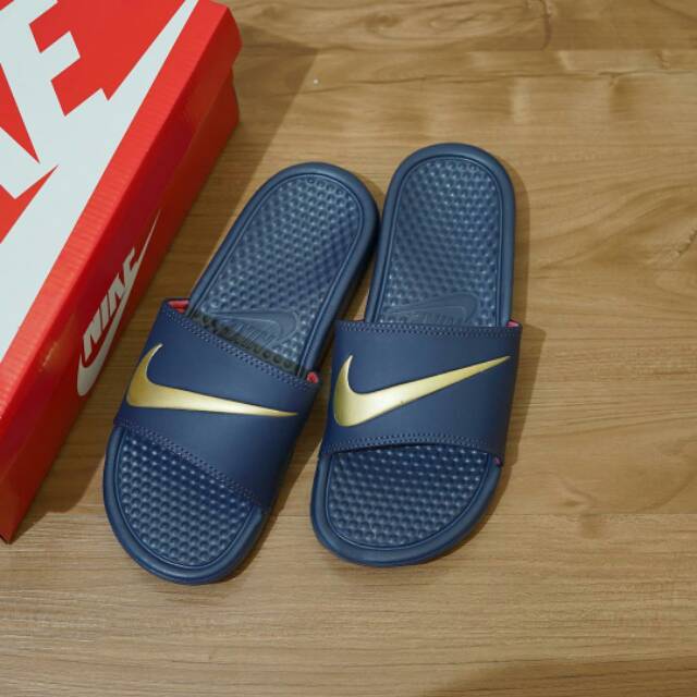 nike flip flops with gold swoosh