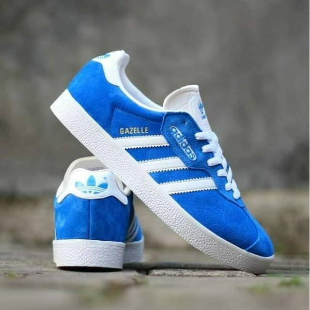 blue and white adidas gazelle