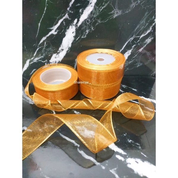 

Pita Organdi List Emas Warna Coklat Tua 1’ (2,5cm) Pita Hiasan Kado Hampers Parcel