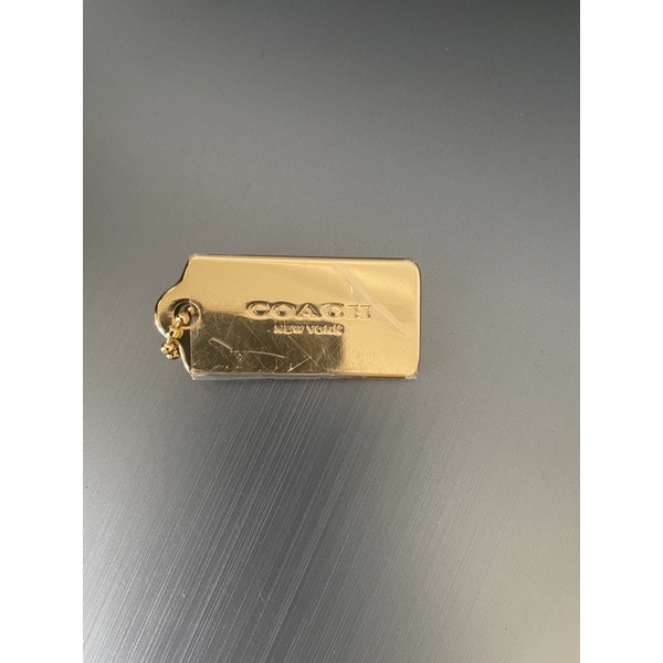 Coach hang tag metal gold