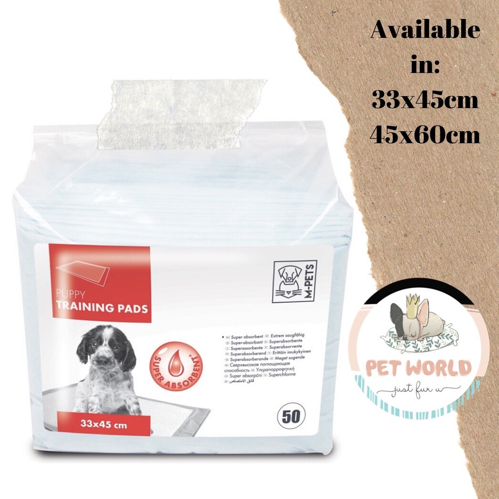 puppy chewing on pee pads