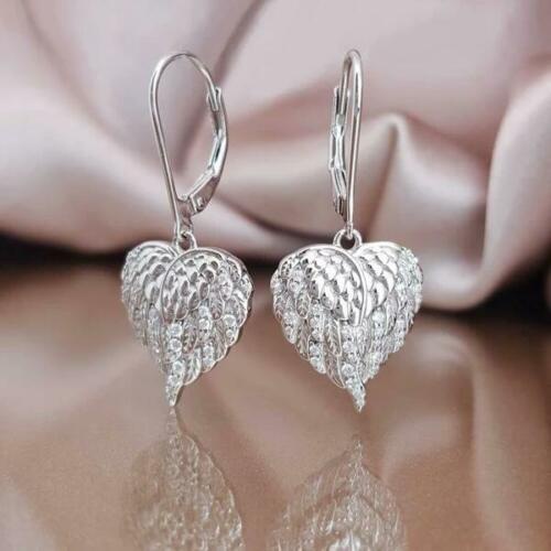 Anting Bentuk Sayap Malaikat Bahan Stainless Steel Aksen Berlian Untuk Wanita