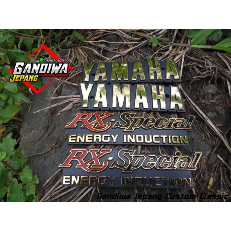 emblem tangki Yamaha RX special model ada baut set emblem bok aki RX spesial ( EMBLEM RX SPESIAL )