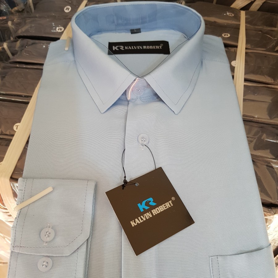 Lesta Langgeng Kemeja Formal Pria Lengan Panjang Standard Bahan Kain Katun Warna Biru Muda Polos