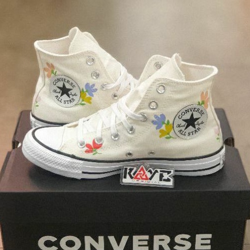 white patterned converse