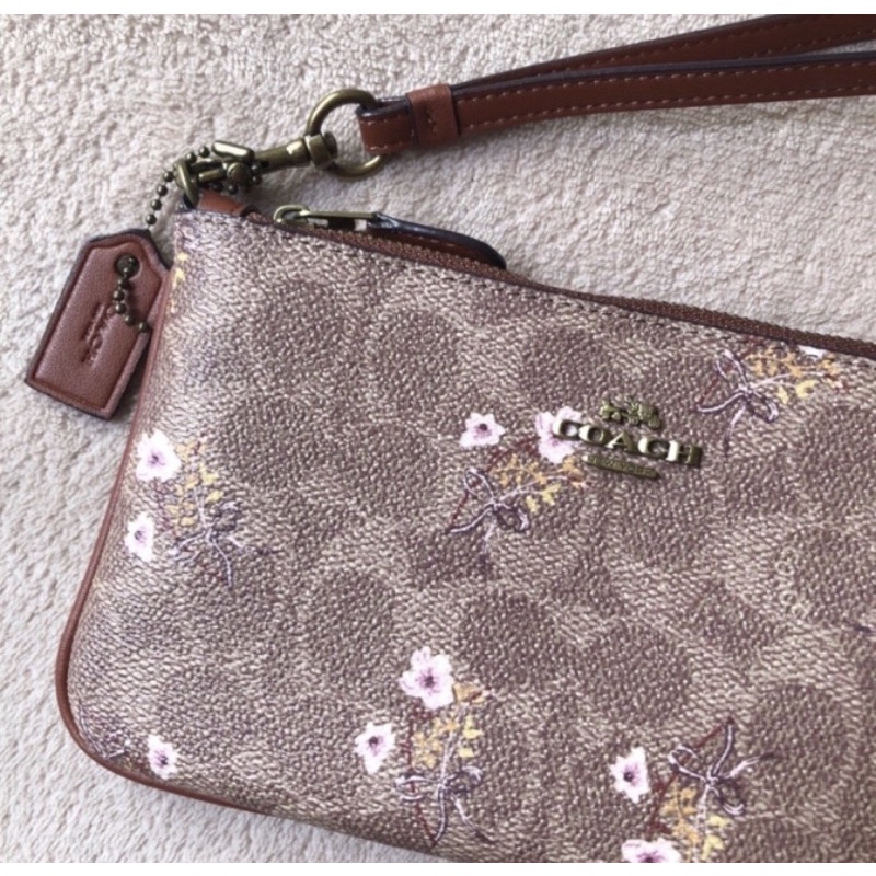 Coach Small Wristlet In Signature Canvas With Floral Bow Print (F67070)