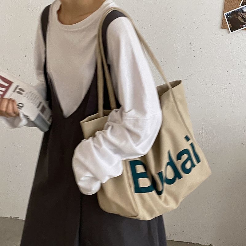 ₪♤❧Sera  Siswa Kasual Kapasitas Besar Tas Wanita Musim Gugur dan Musim Dingin 2022 Baru Fashion Huruf Kanvas Tas Gaya Korea Single bahu Tas Kain