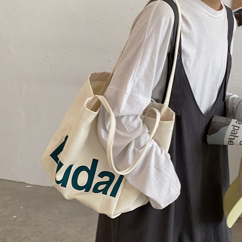 ₪♤❧Sera  Siswa Kasual Kapasitas Besar Tas Wanita Musim Gugur dan Musim Dingin 2022 Baru Fashion Huruf Kanvas Tas Gaya Korea Single bahu Tas Kain