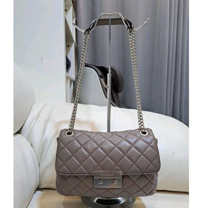 MK sloan grey quilted sling bag