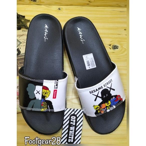 fg-7 SANDAL SLIDE KAWS SUPREME SESAME / SANDAL SELOP KAWS GRADE ORI Termurah