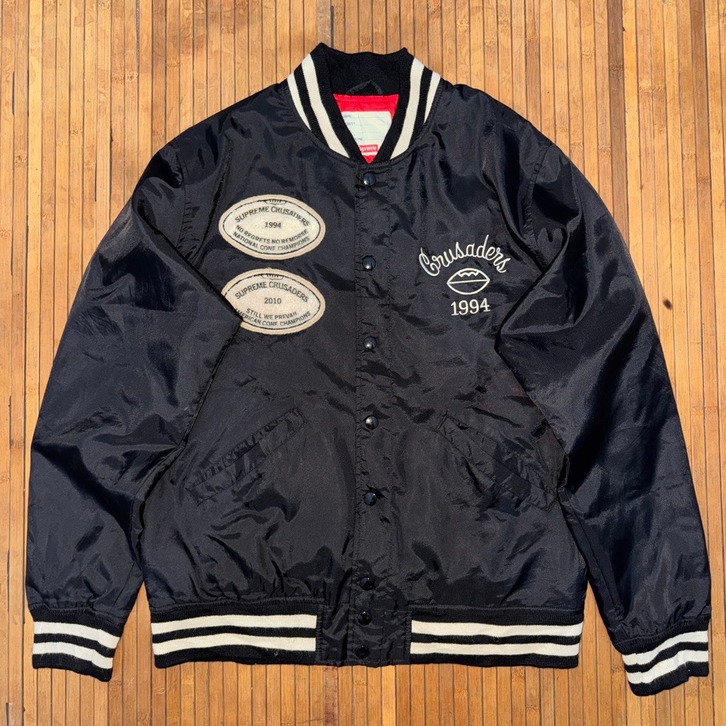 SUPREME x CRUSADERS STREETWEAR BLACK TIPPED WHITE EMBROIDERED LOGO NYLON VARSITY JACKET