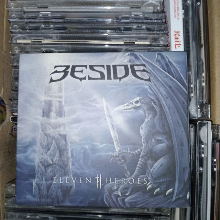CD BESIDE ALBUM ELEVEN HEROES