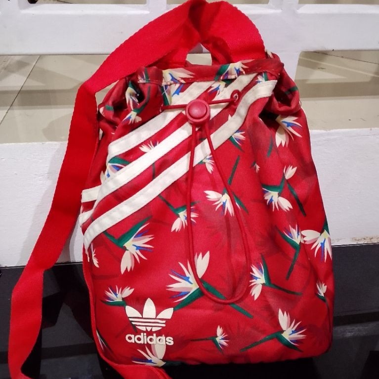 Preloved mini bucket backpack featuring a red floral "Birds of Paradise"  Preloved