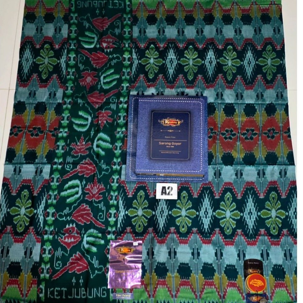SARUNG KETJUBUNG GOYOR MOTIF PELANGI RED/GOLD JAHIT TENGAH