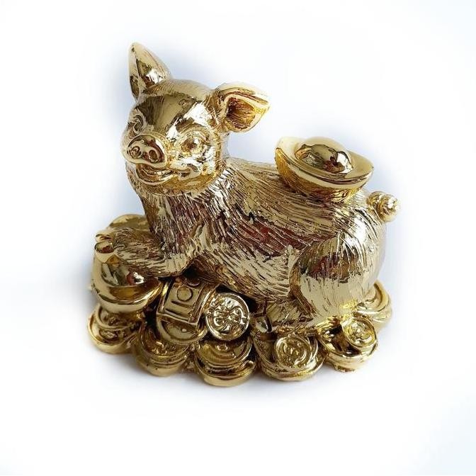 Patung babi warna gold membawa emas | lambang keberuntungan