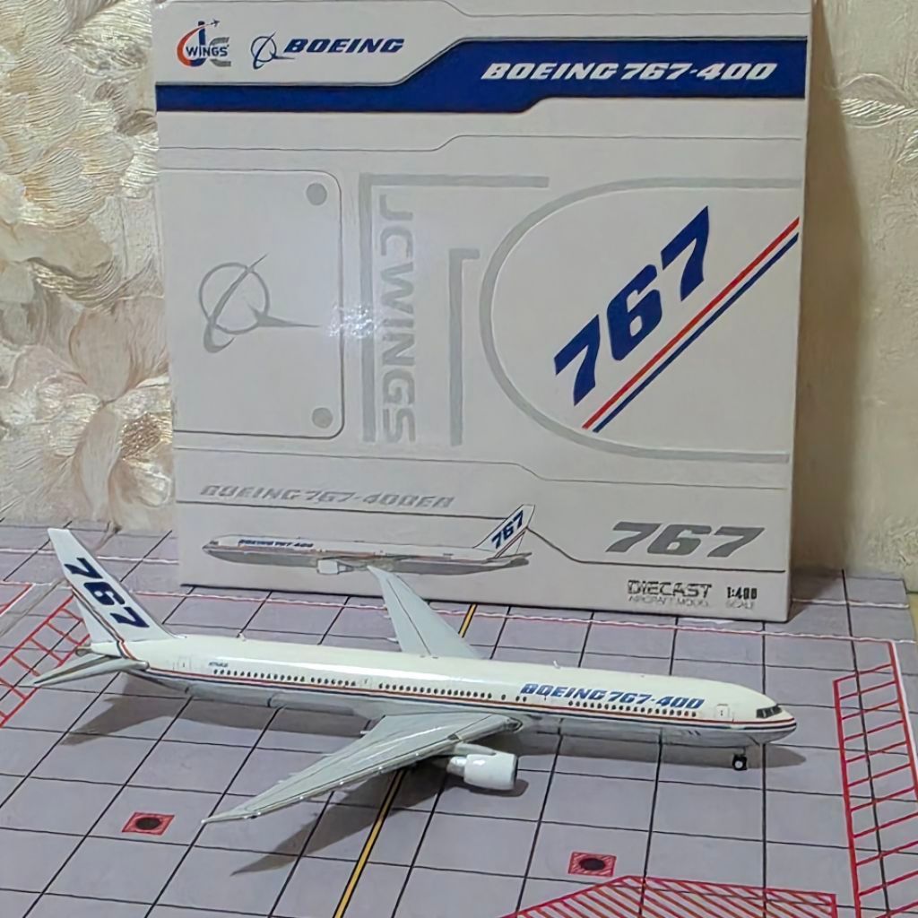 miniatur diecast pesawat Boeing 767-400ER dengan corak purwarupa (house livery) dari Boeing berregis