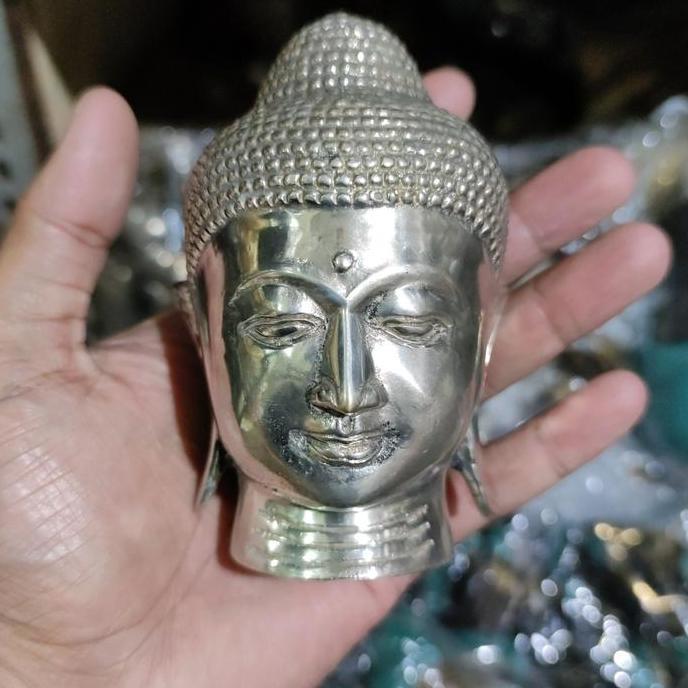 patung kepala buddha logam
