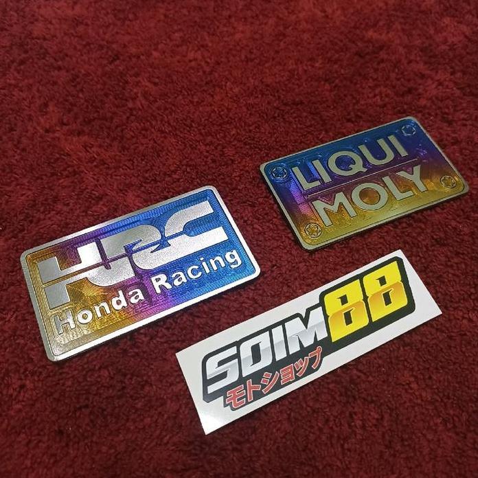 PROMO EMBLEM HUGGER AIRBLADE TITANIUM VARIO/PCX CBU