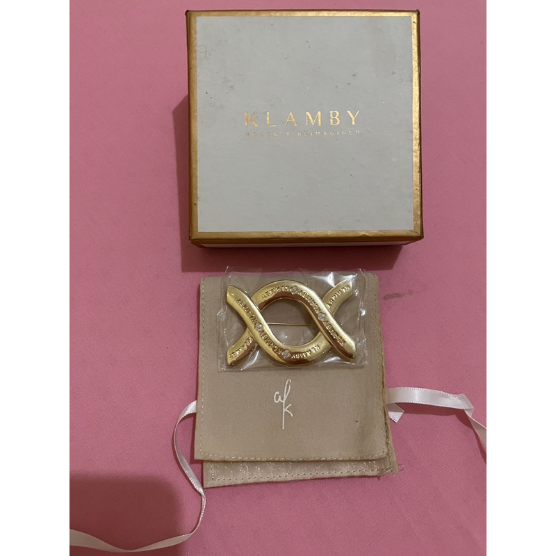 wearing klamby monogram brooch