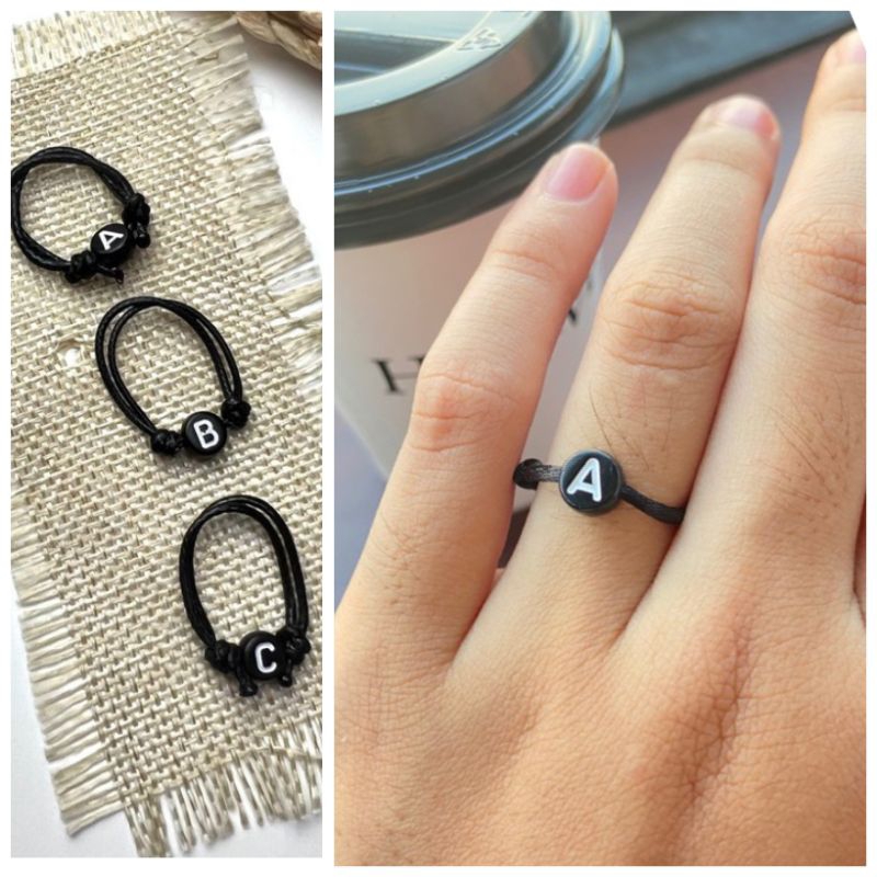 CINCIN INISIAL HURUF BULAT/BUNDAR HITAM TULISAN PUTIH TALI KOREA 1 MM  (XSEMPLAR)