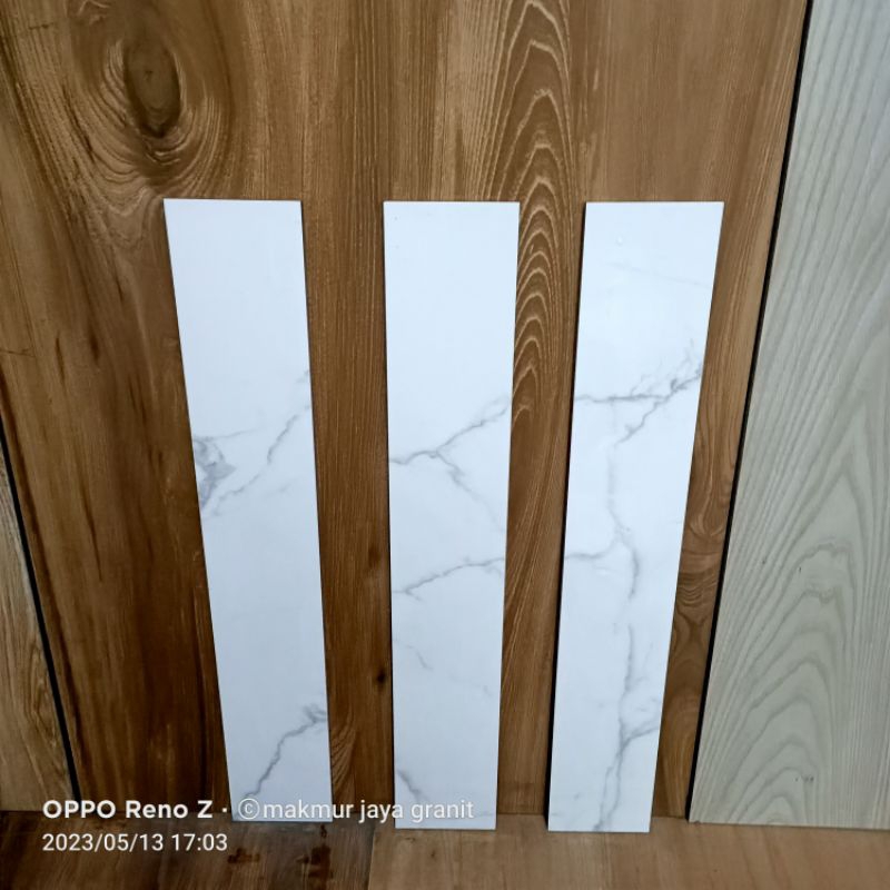 Plint granit 10x60 putih motip calacat