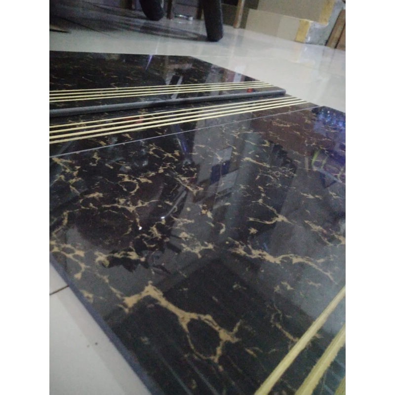 granit tangga hitam motif emas 30x60