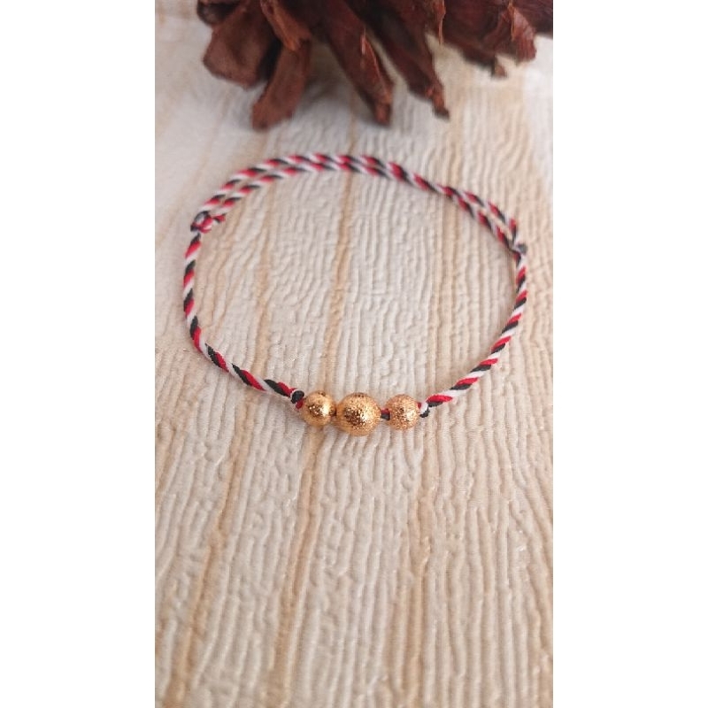 gelang tridadu liontin bola pasir