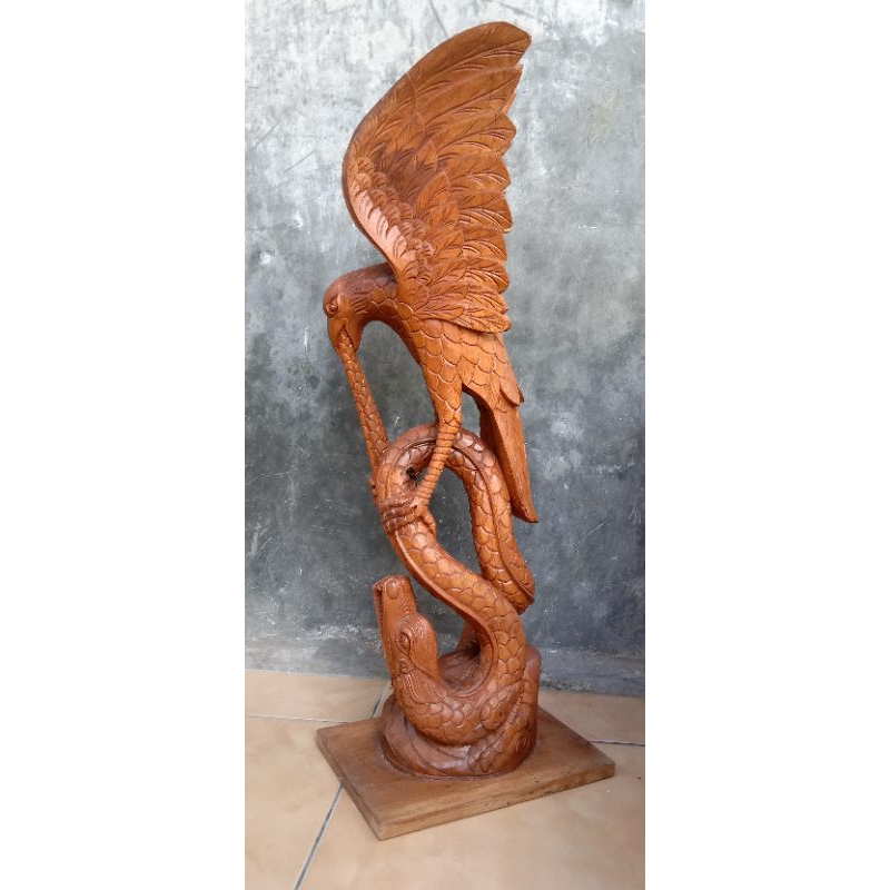 ukiran jepara kayu jati elang vs ular