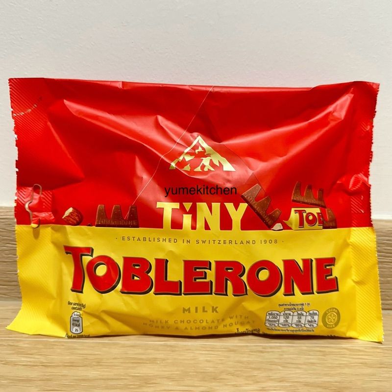 

Preorder Toblerone Tiny Swiss Milk Chocolate with Almond Nougat & Honey Flavoured 200 g - Coklat Swiss