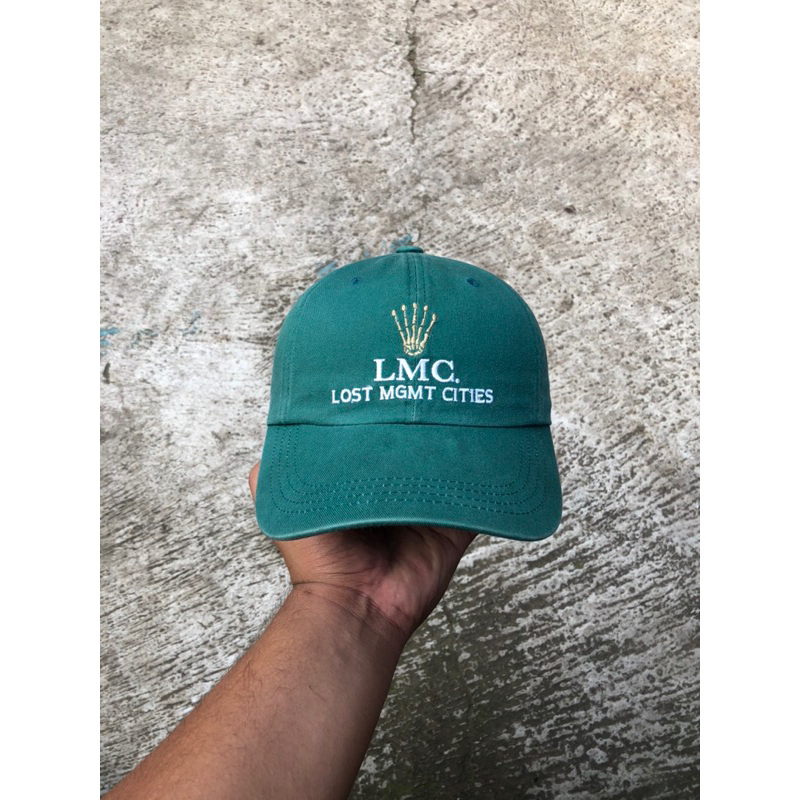 Topi LMC (Lost Management Cities) “Rolex Looklike Script” Baseball Cap
