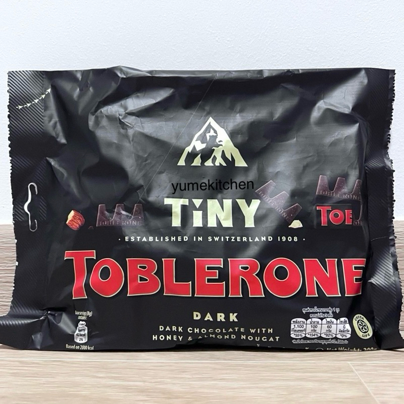 

Toblerone Tiny Swiss Dark Chocolate with Almond Nougat & Honey Flavoured 200 g - Coklat Swiss